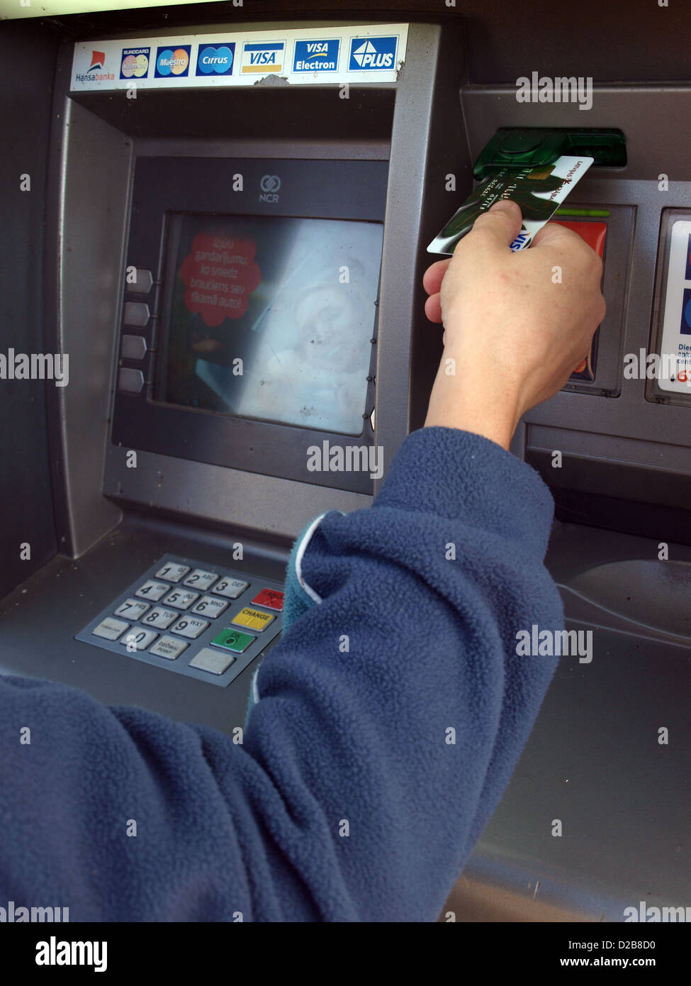 Hand inserting credit card or getting money from ATM close up Stock Photo