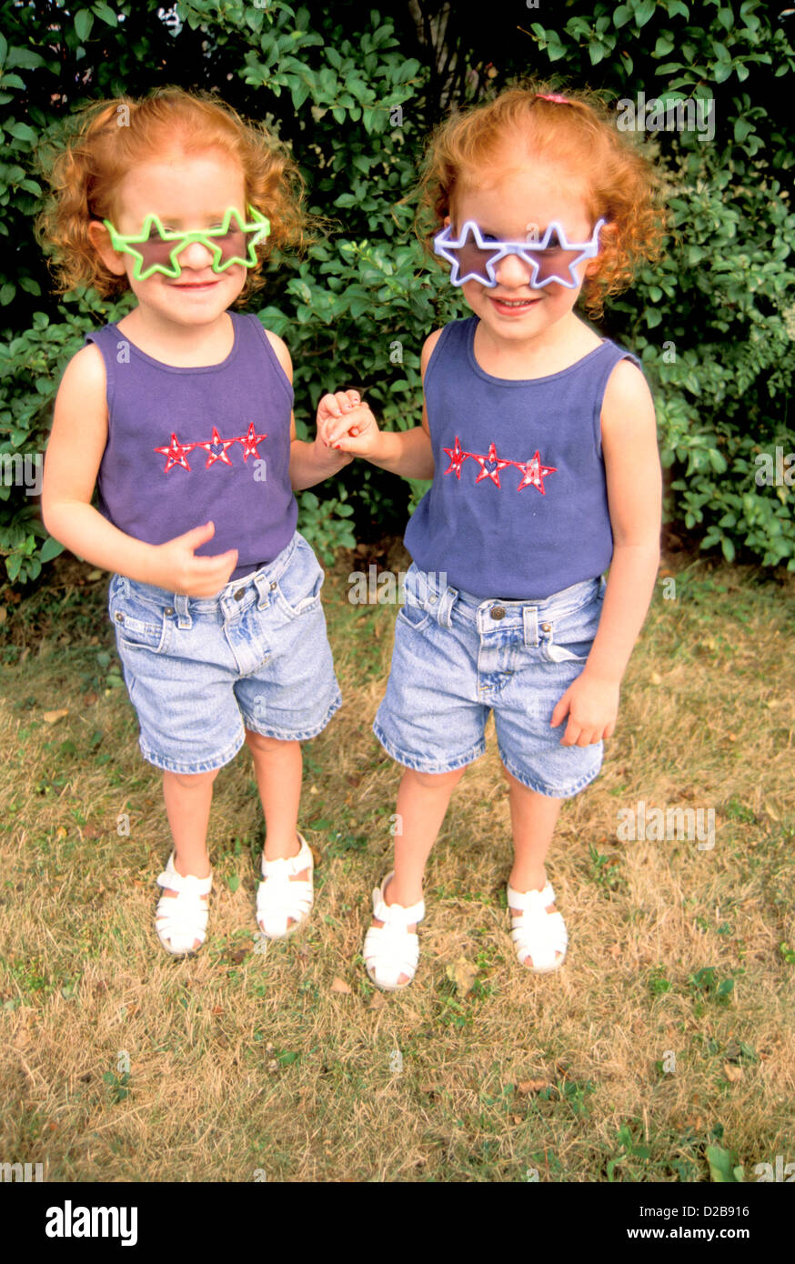 Twin Girls Wearing Star Shaped Sun Glasses Stock Photo