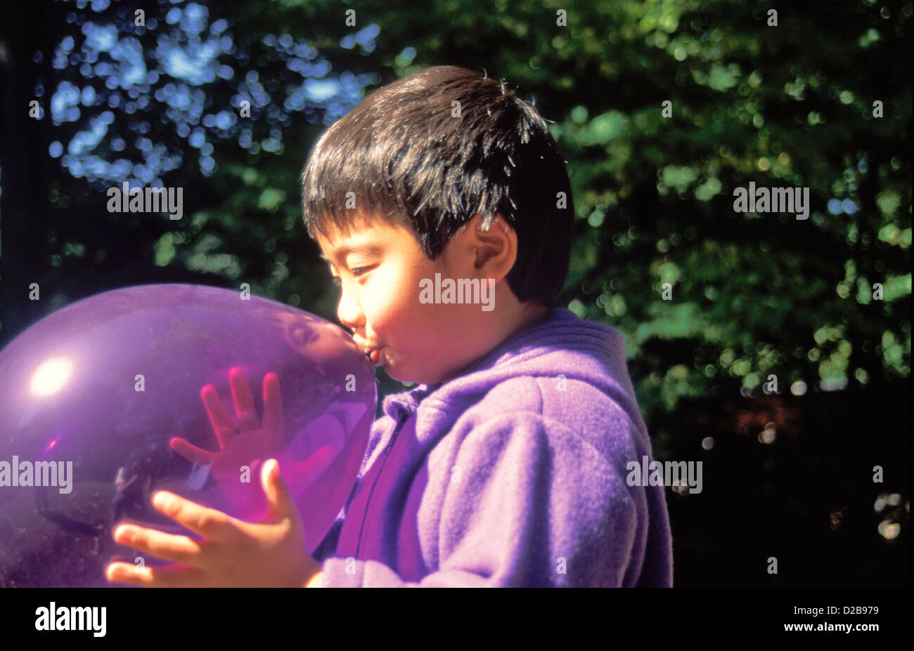 Boy blowing up balloon hires stock photography and images Alamy