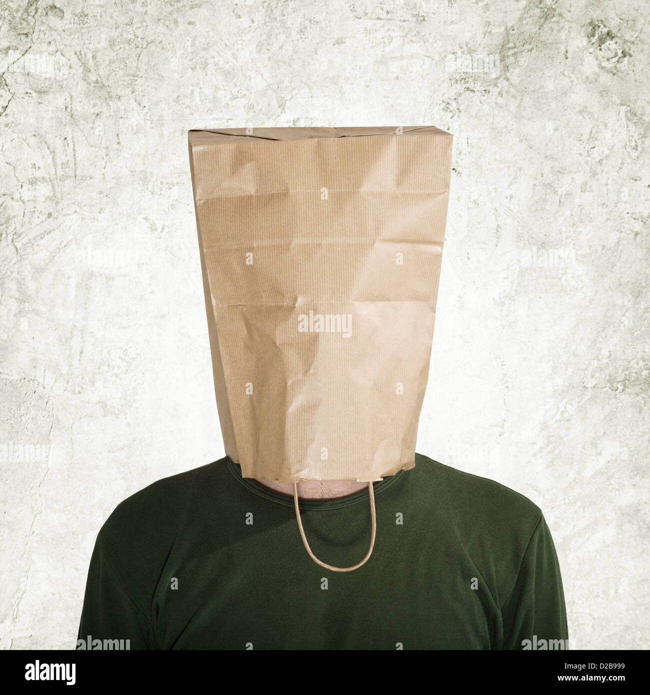 head in the paper bag, man hidden behind the shopping bag. Stock Photo