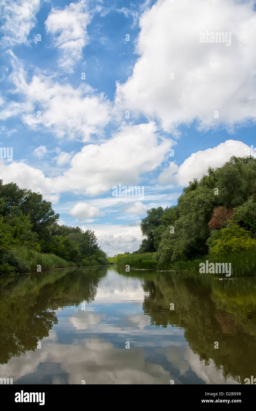 Cloudy summer sky reflected in the River Tisza Hungary Stock Photo