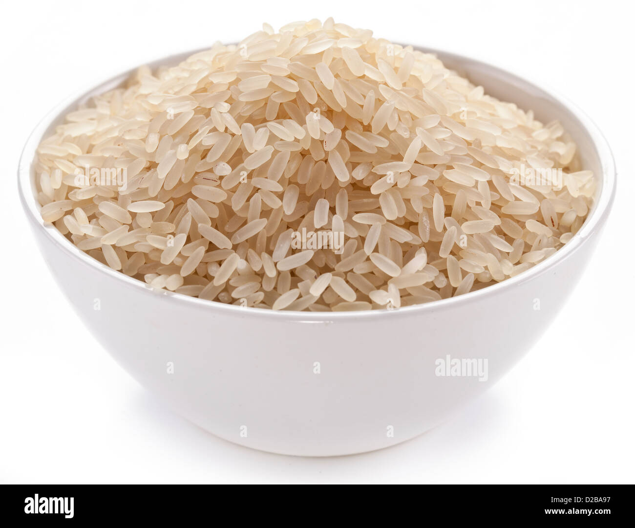 Uncooked rice in a bowl on a white background. Stock Photo