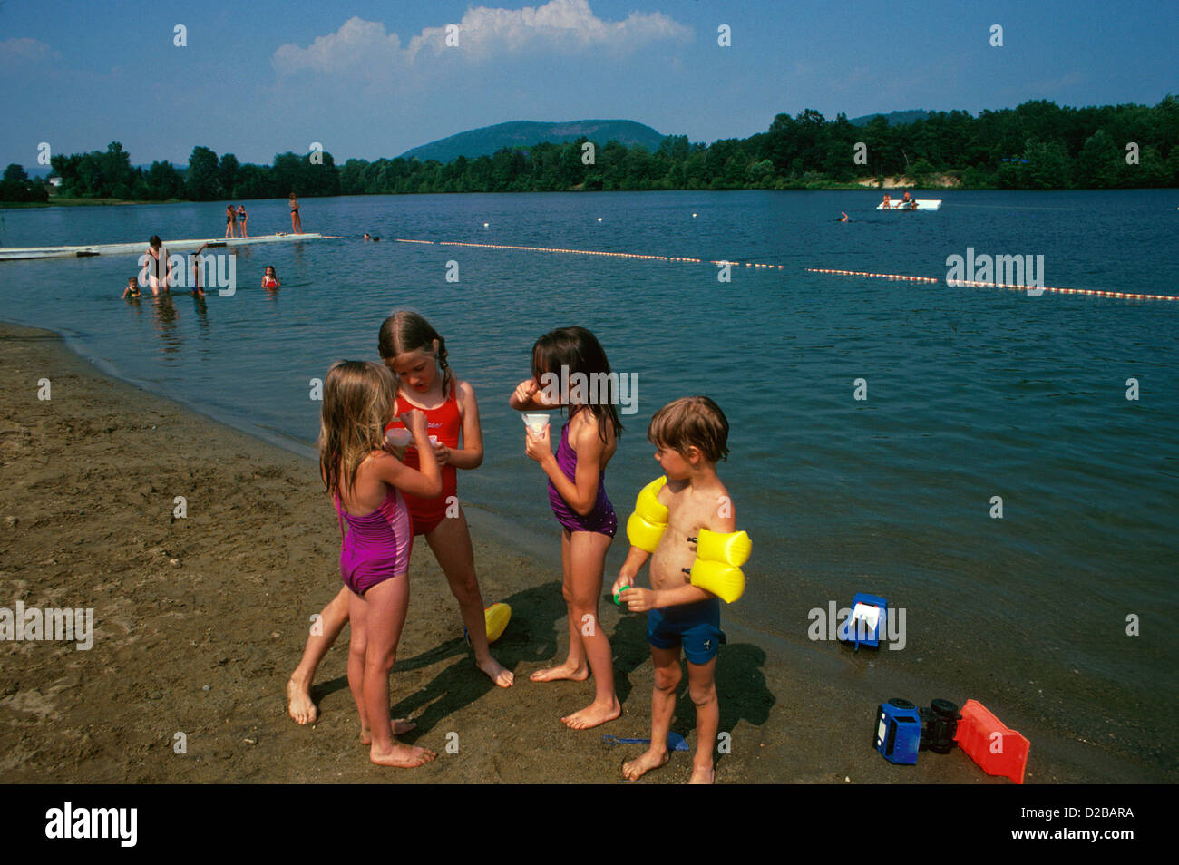 Four Children On The Beach, Boys And Girls, Flotation Arm Bands Stock Photo