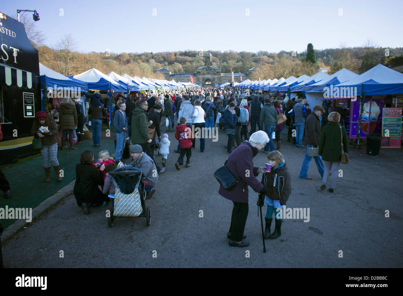 Grandmother giving her grandson a warming drink on a cold November day at Chatsworth Xmas market Stock Photo