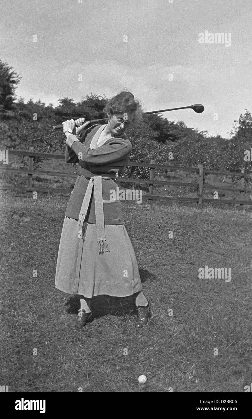 A lady golfer driving on the fairway, c. 1930 Stock Photo