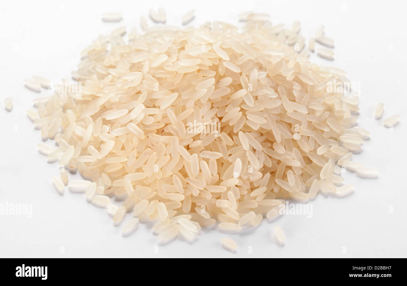 Handful of rice on a white background. Stock Photo
