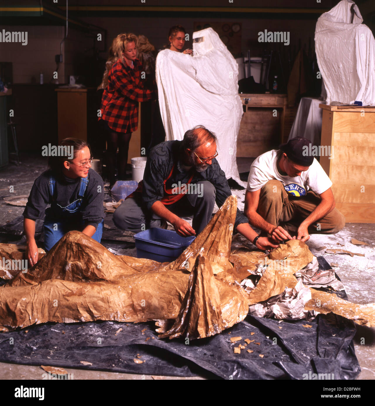 Colorado, Gunnison, Western State College. Professor And Students Working On Large Figurative Sculpture. Stock Photo