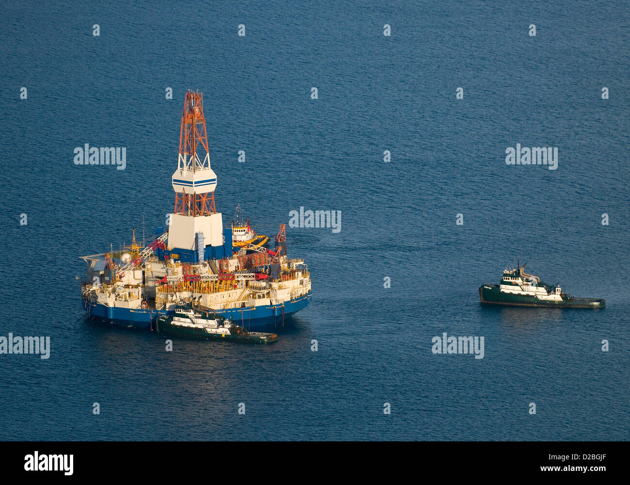 The stranded Arcticclass drilling unit the Kulluk is towed to a safe