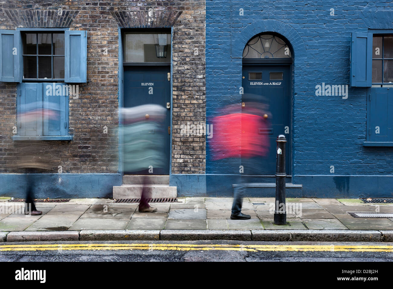 number 11 and 11 and a half Fournier street in Spitalfields with blurred people walking past the doors Stock Photo