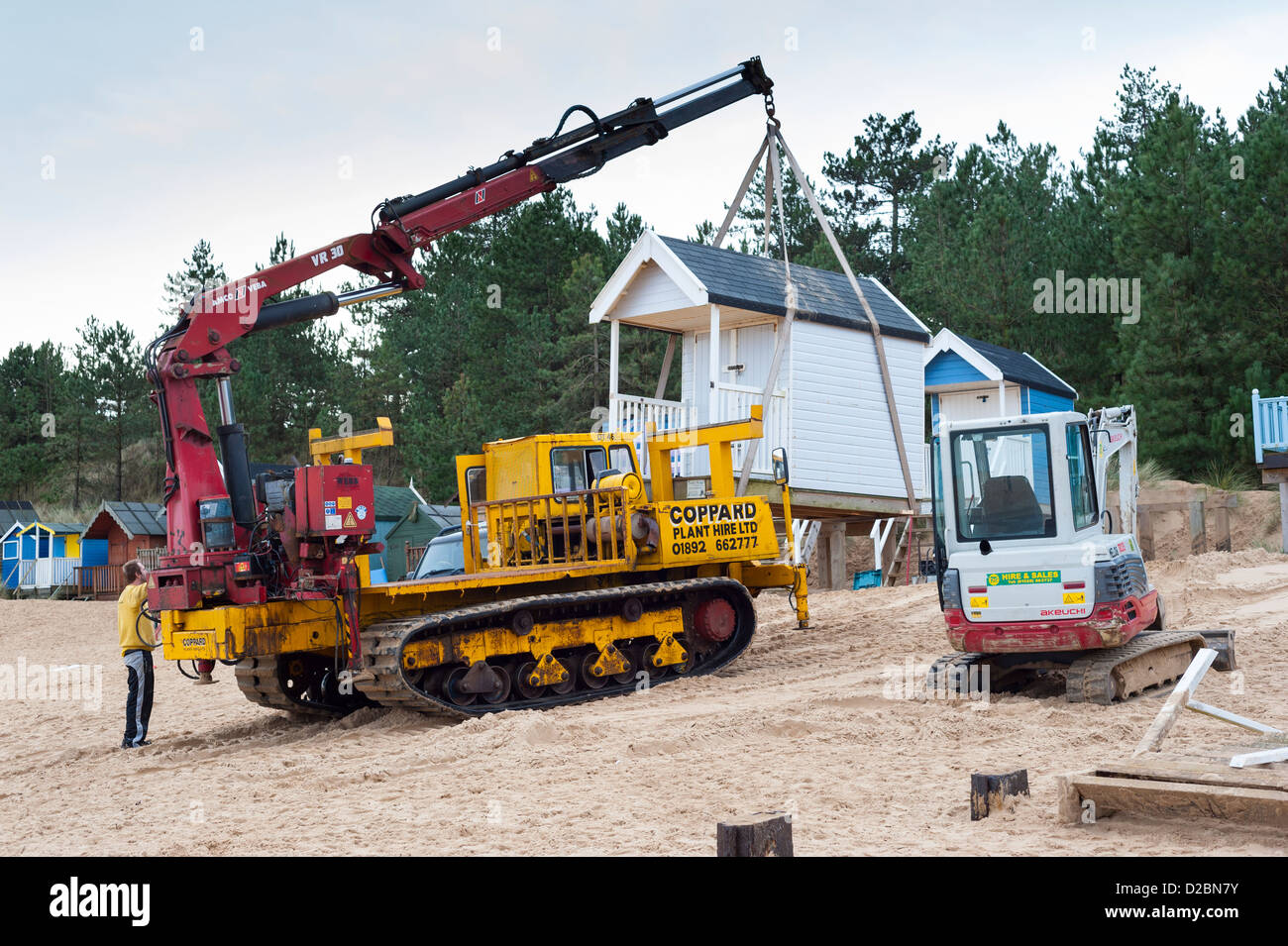 Crane lifting holiday beach hut into position, wells beach, wells next sea, Norfolk, England Stock Photo