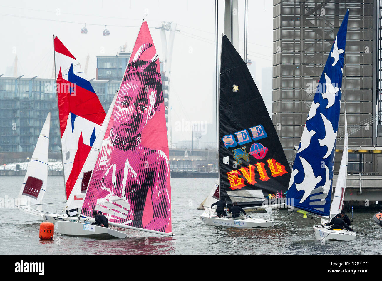 Star Class boats are raced by 20 Olympic and World champion sailors – including triple Olympic medalist Iain Percy, double Olympic medalist Andrew Simpson, Olympic medalists Pippa Wilson, Ian Walker, Luke Patience and Xavier Rohart .  They are using boats with sails designed by a range of artists -  Eine (see no evil), Julian Opie (black lines white sail) , Goldie (pink sail with face) and David Begbie (black and white face). This is the first time sailing and art has been brought together in a match racing series. The London Boat Show, Excel centre, Docklands, London, UK 19 January 2013. Stock Photo