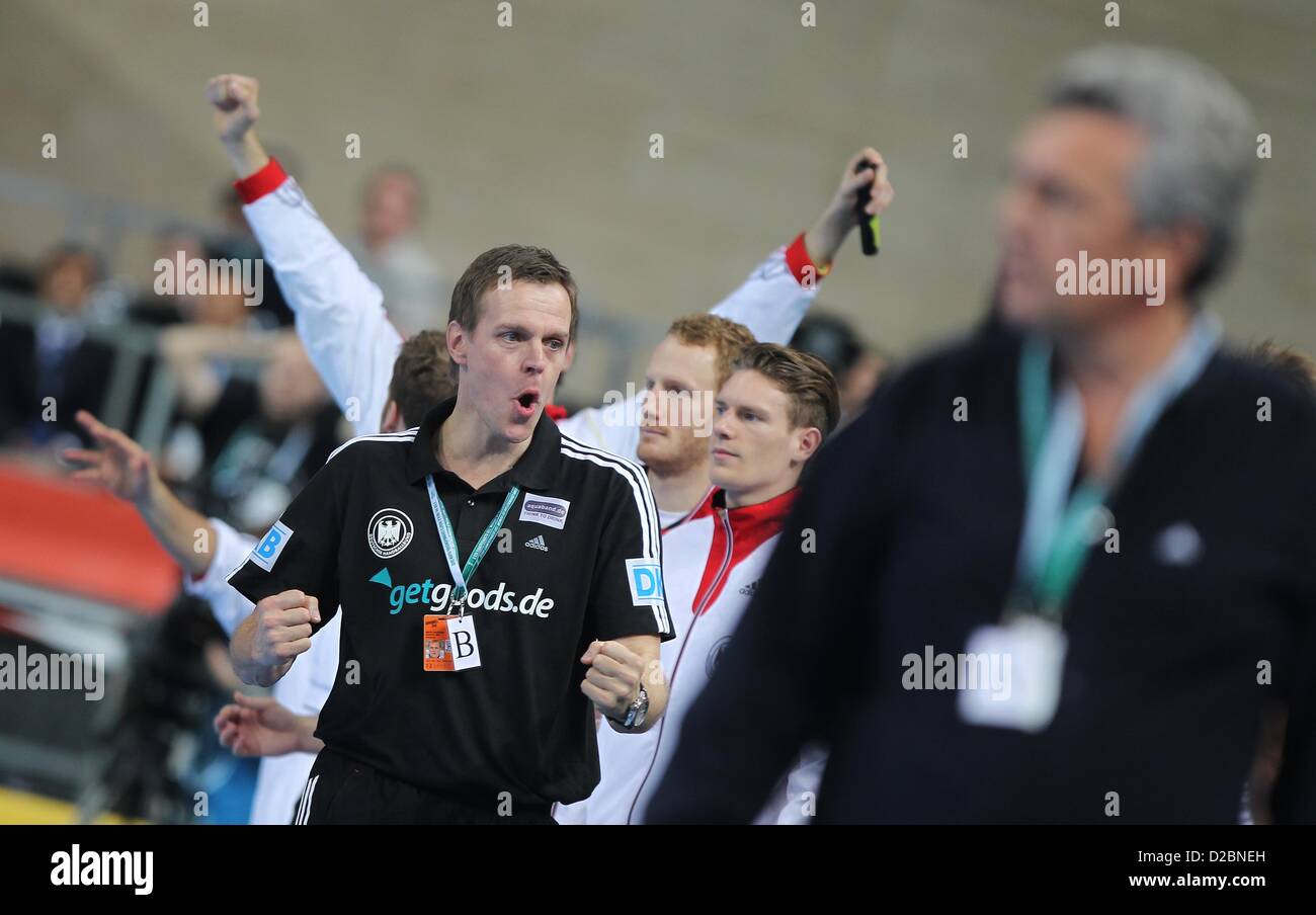 German Head coach Martin Heuberger (C) of Germany celebrates while head coach Claude Onesta (R) of France looks on after the men's Handball World Championships main round match Germany vs France in Barcelona, Spain, 18 January 2013. Germany won 32:30. Photo: Fabian Stratenschulte Stock Photo