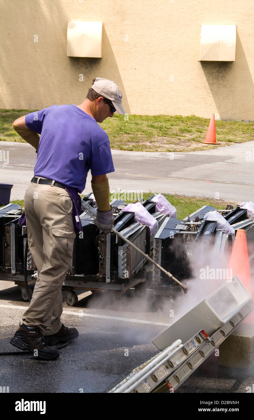 Man Cleaning Cleaning Air Conditioning Units For Better Energy Efficiency And Cleaner Air Circulation Stock Photo