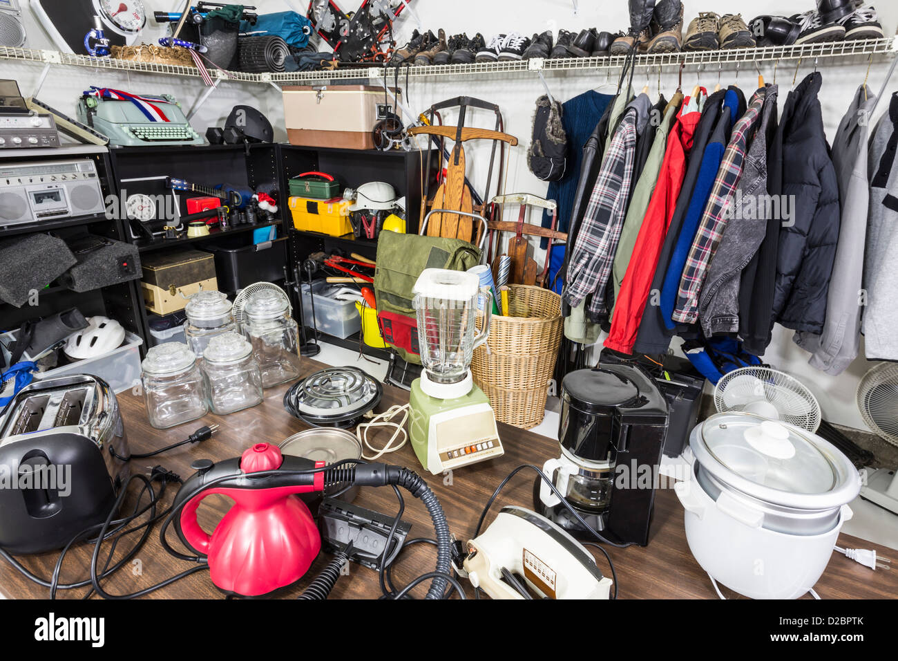 Interior garage sale, housewares, clothing, sporting goods and toys. Stock Photo