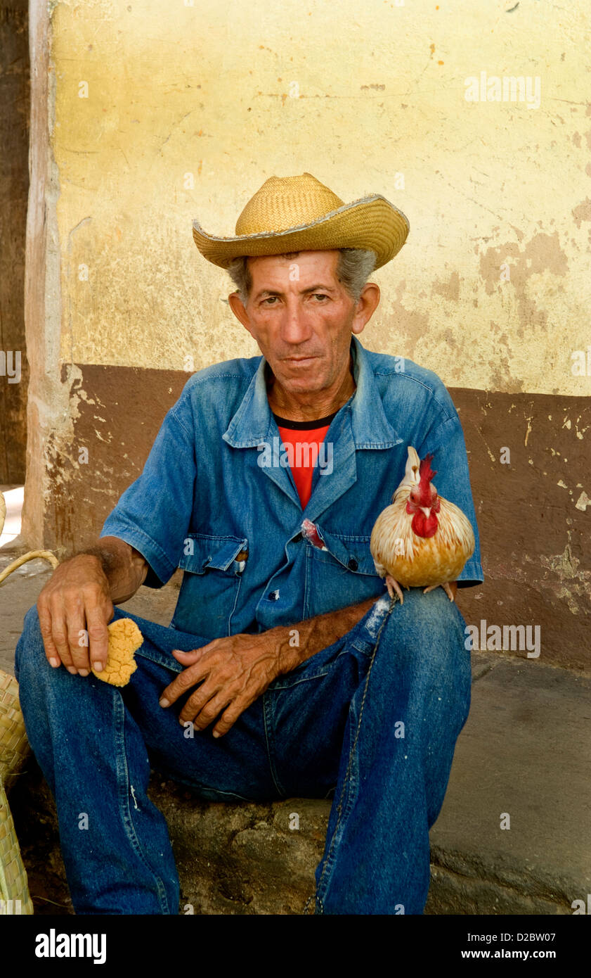 Old Man With His Chicken On Streets Of Old Village Of Trinidad, Cuba Stock Photo