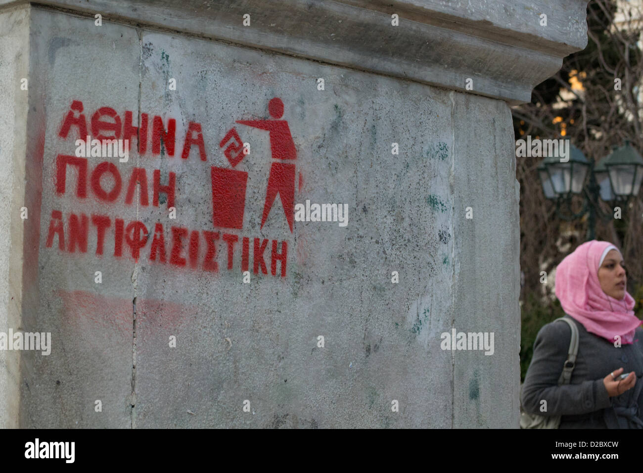 Athens, Greece, 19th Januray 2013. Immigrants and locals take to the streets to condemn fascism and protest against racist attacks and the neo-nazi party Golden Dawn. Stencil on marble reads 'Athens, an antifascist city'. Credit:  Nikolas Georgiou / Alamy Live News Stock Photo