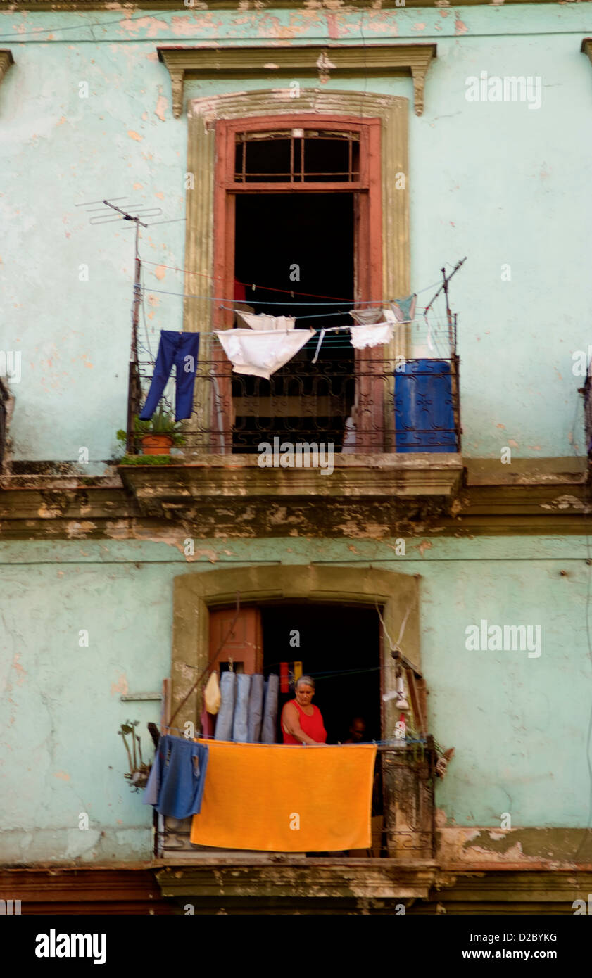 Havana, Cuba, Woman Hanging Laundry From Porch Stock Photo