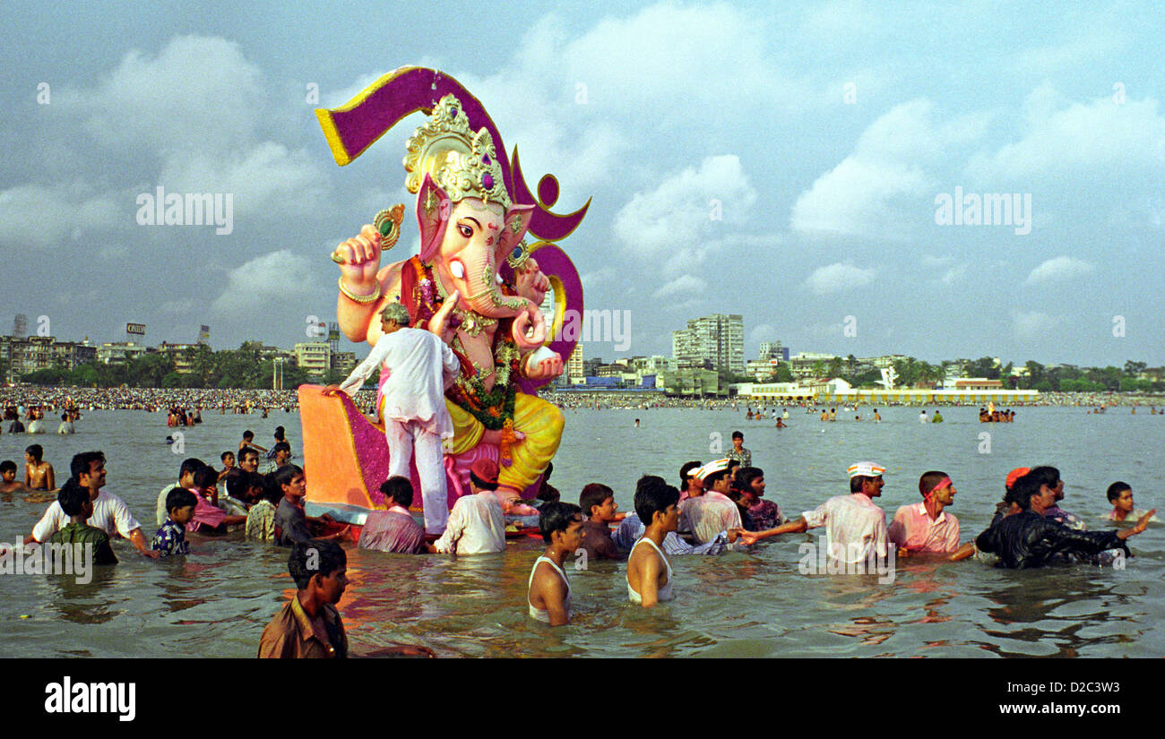 Huge Lord Ganesh Idol Being Immersed In The Sea At Girgaum Chowpatty, Bombay Now Mumbai, Maharashtra, India Stock Photo