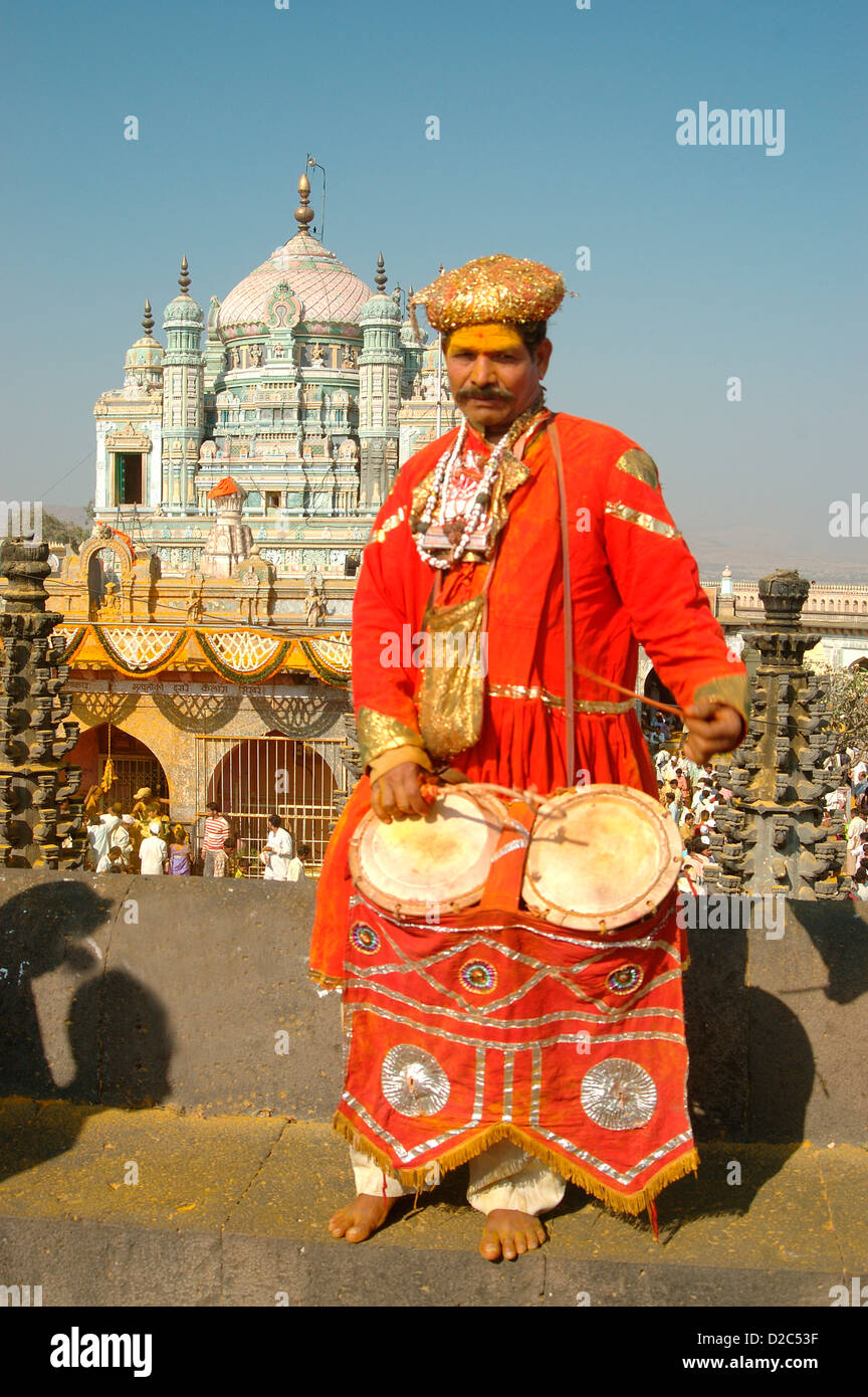 Indian Musical Instrument Player Sambal With Background Of Khandoba At Jejuri, Pune, Maharashtra, India Stock Photo