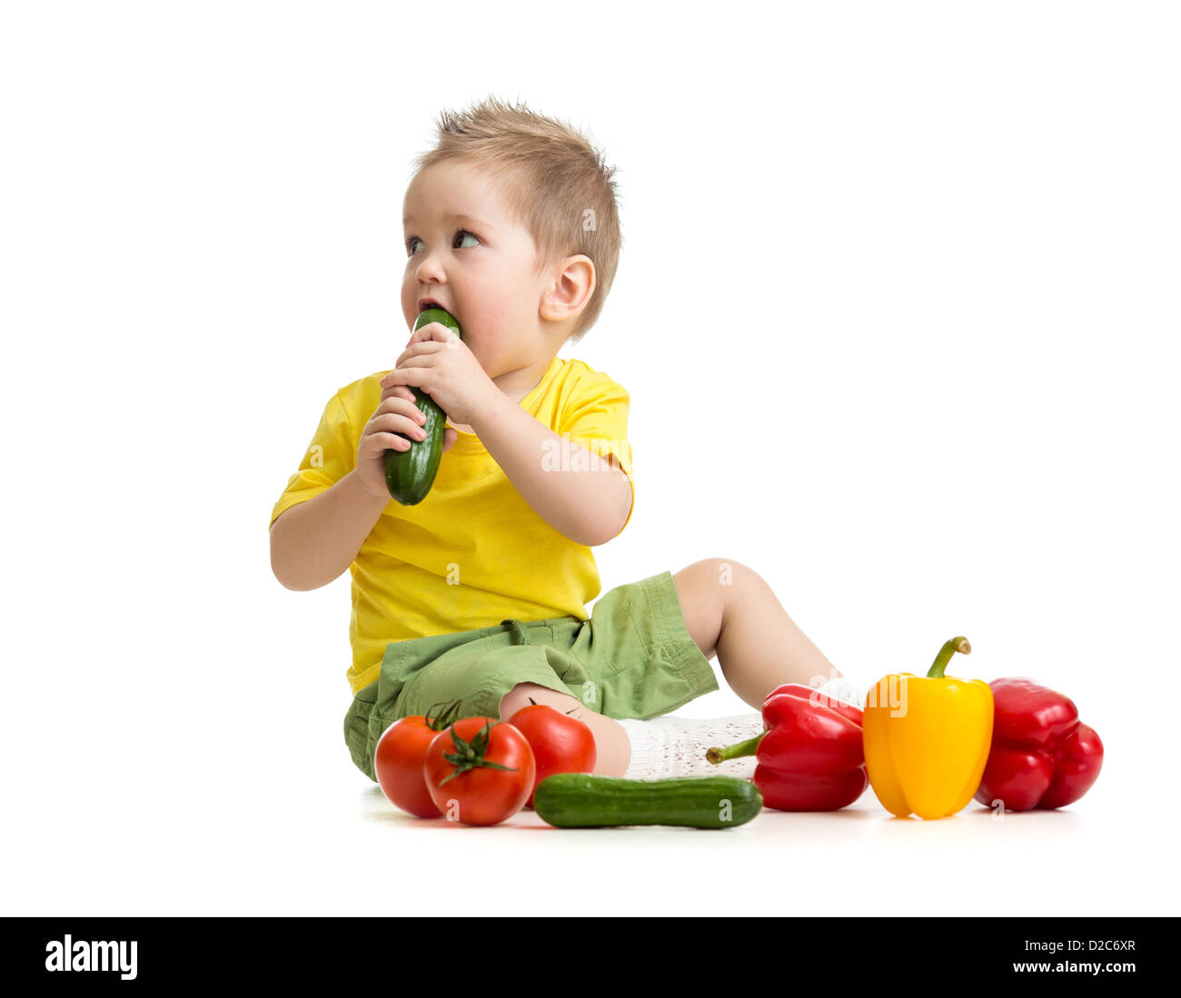 kid eating healthy food and looking aside Stock Photo