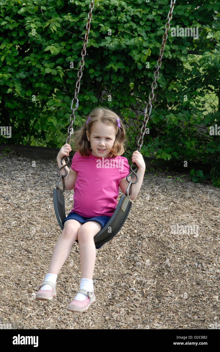4 1/2 -Yr. Old Girl, Sling Swing, Playground Stock Photo