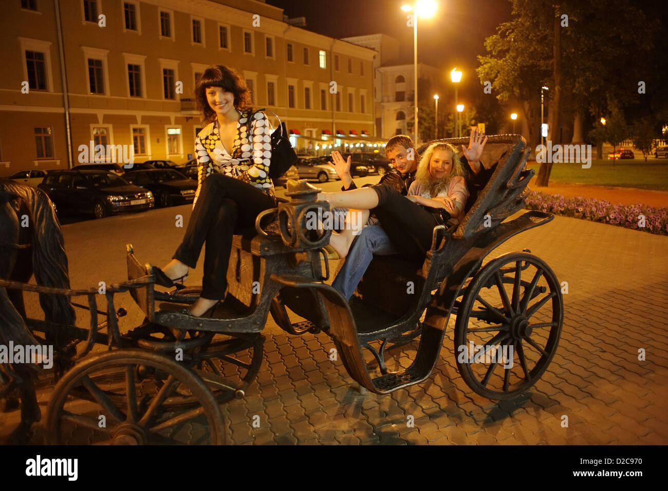 Minsk, Belarus, young people in an iron horse-drawn carriage in front of the town hall Stock Photo