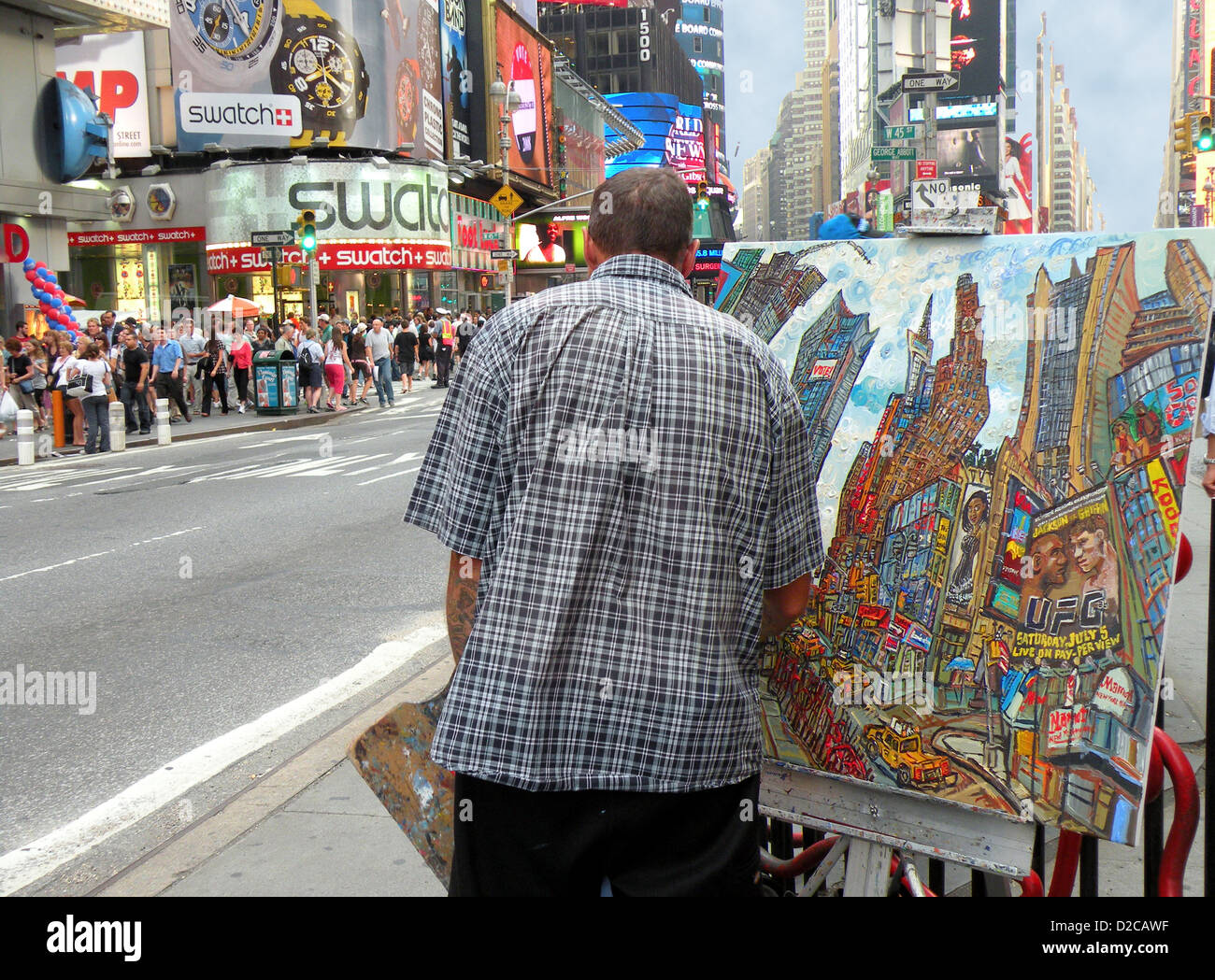 A painter Times Square painting a picture of a Midtown Manhattan scene to be sold to tourists. Stock Photo