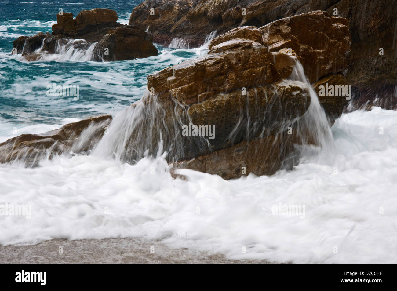 Waves breaking on rocky beach Stock Photo