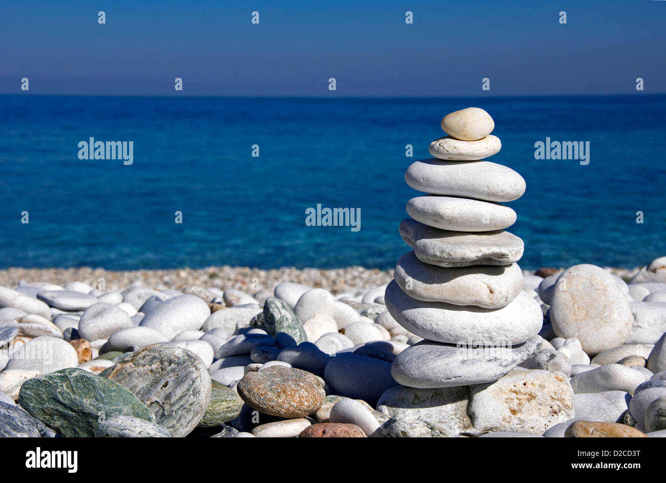 Stacked pebbles on pebble beach Stock Photo