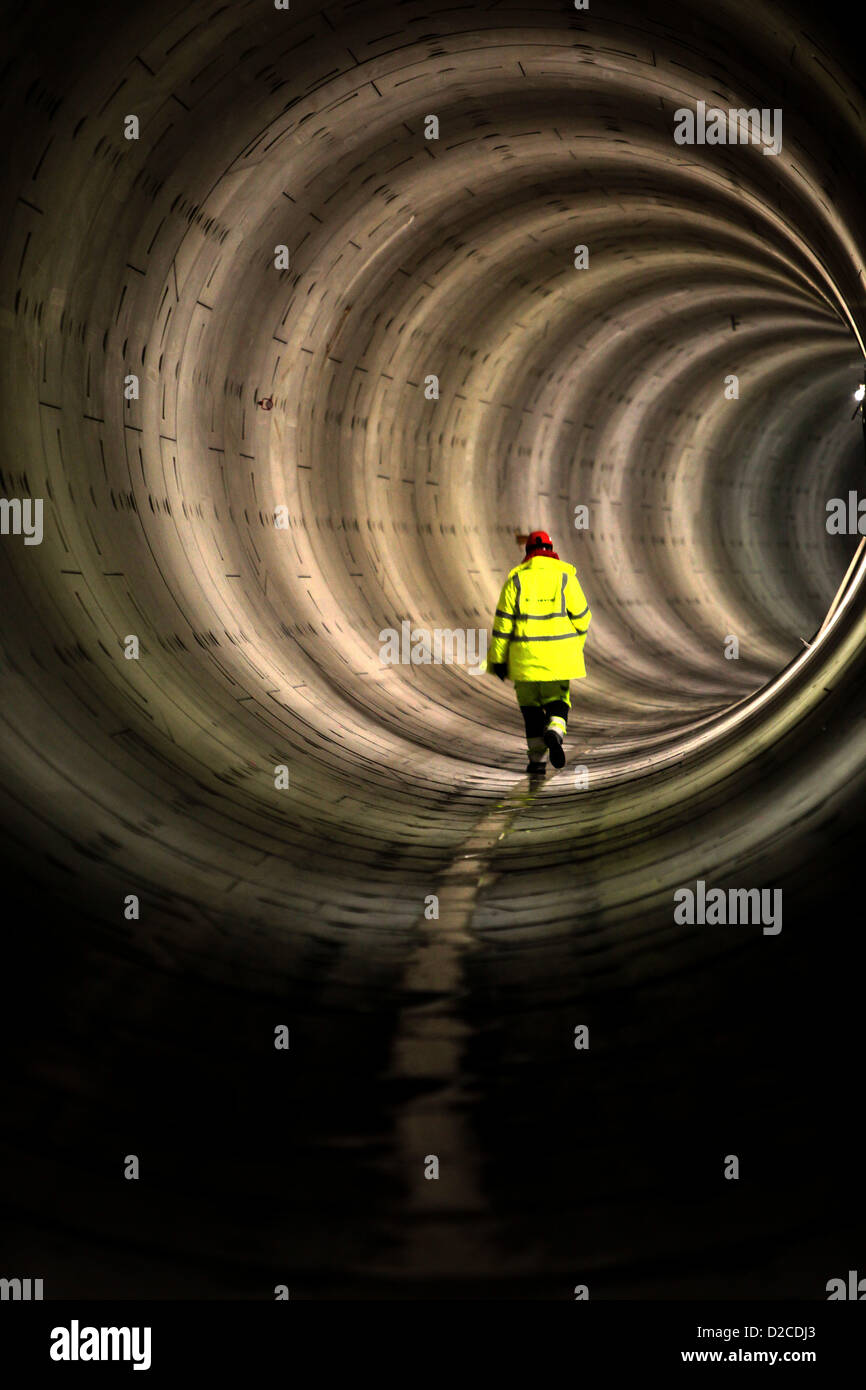 Underground construction, tunnel, worker going through a tunnel Stock