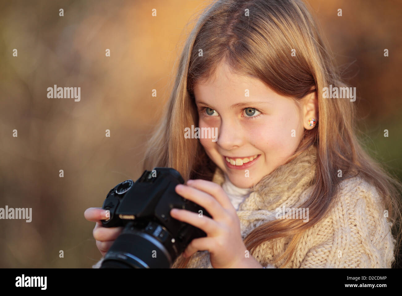 Young girl having fun with a camera. Stock Photo