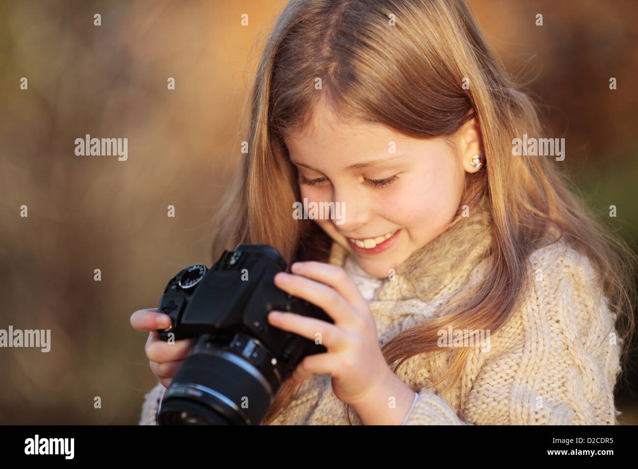 Young girl looking at a photo she has just taken. Stock Photo