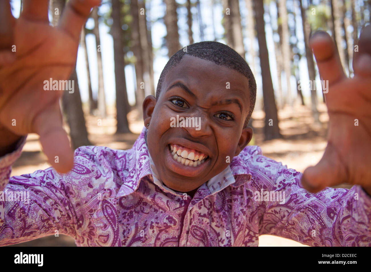 young african boy looking to the camera and pulling funny face in the woods  Stock Photo - Alamy