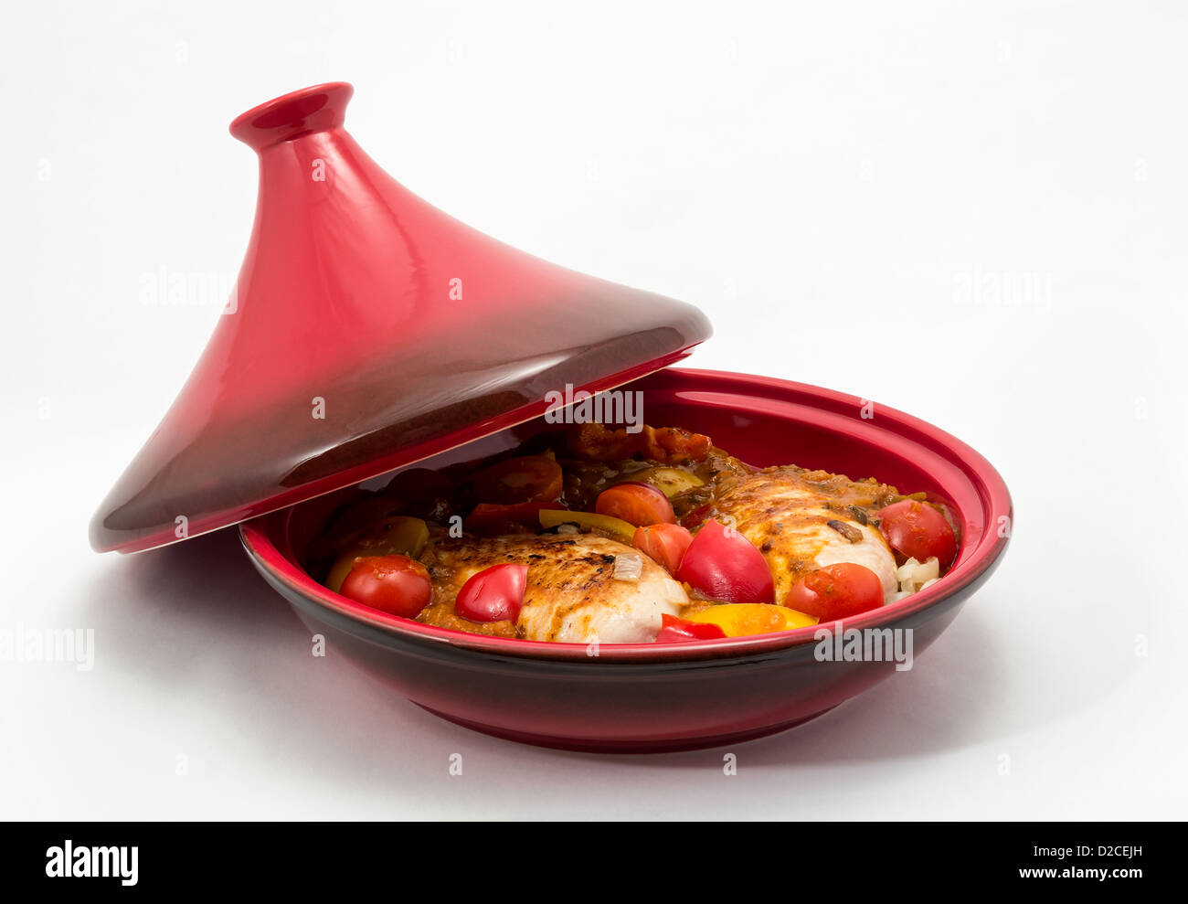 Tagine (Tajine) a type of cookware from Morocco shown here with a prepared chicken dish ready for cooking. Stock Photo