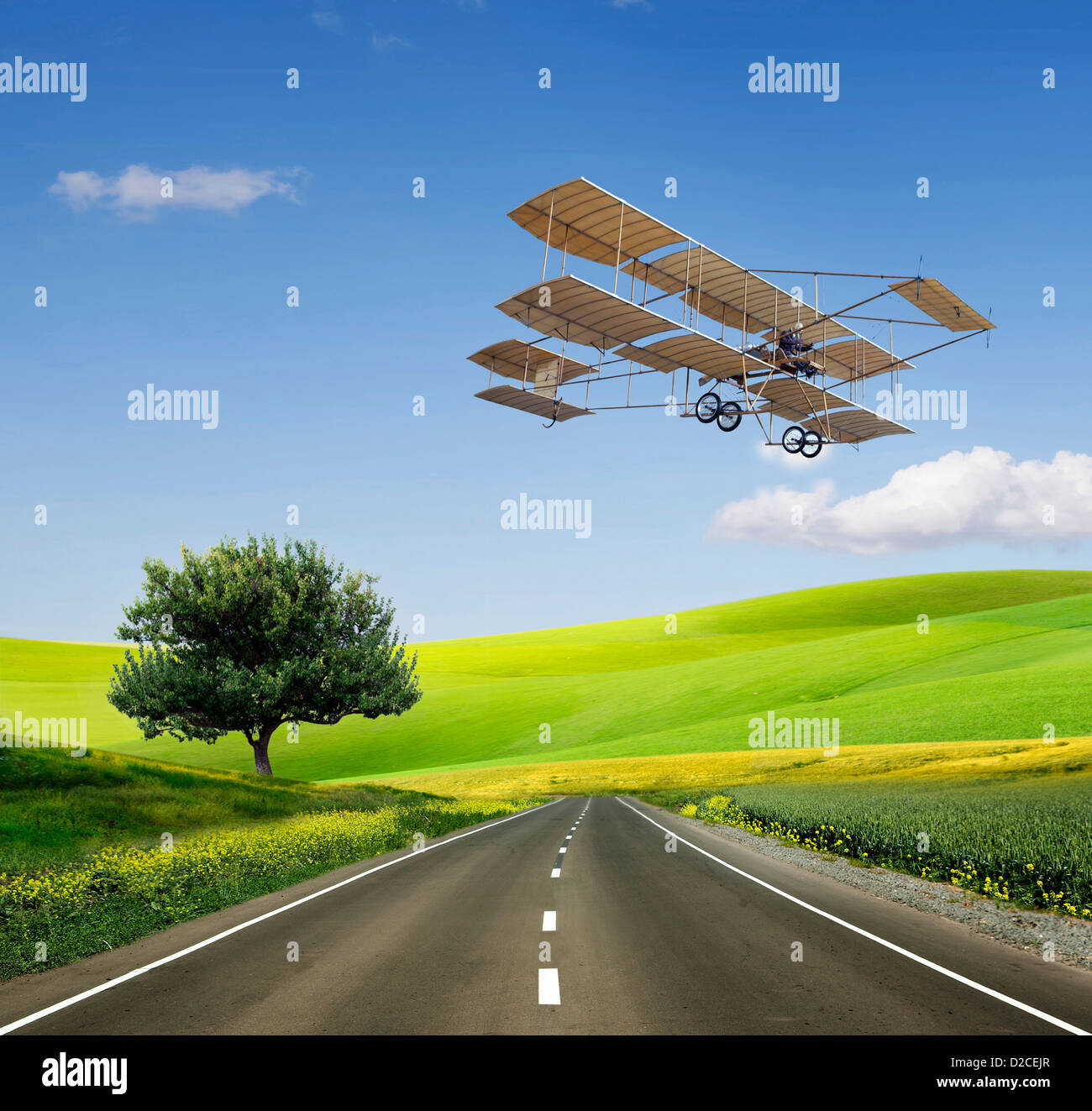 Green Grass Field Landscape with fantastic clouds in the background and old aircraft on the green field and road Stock Photo