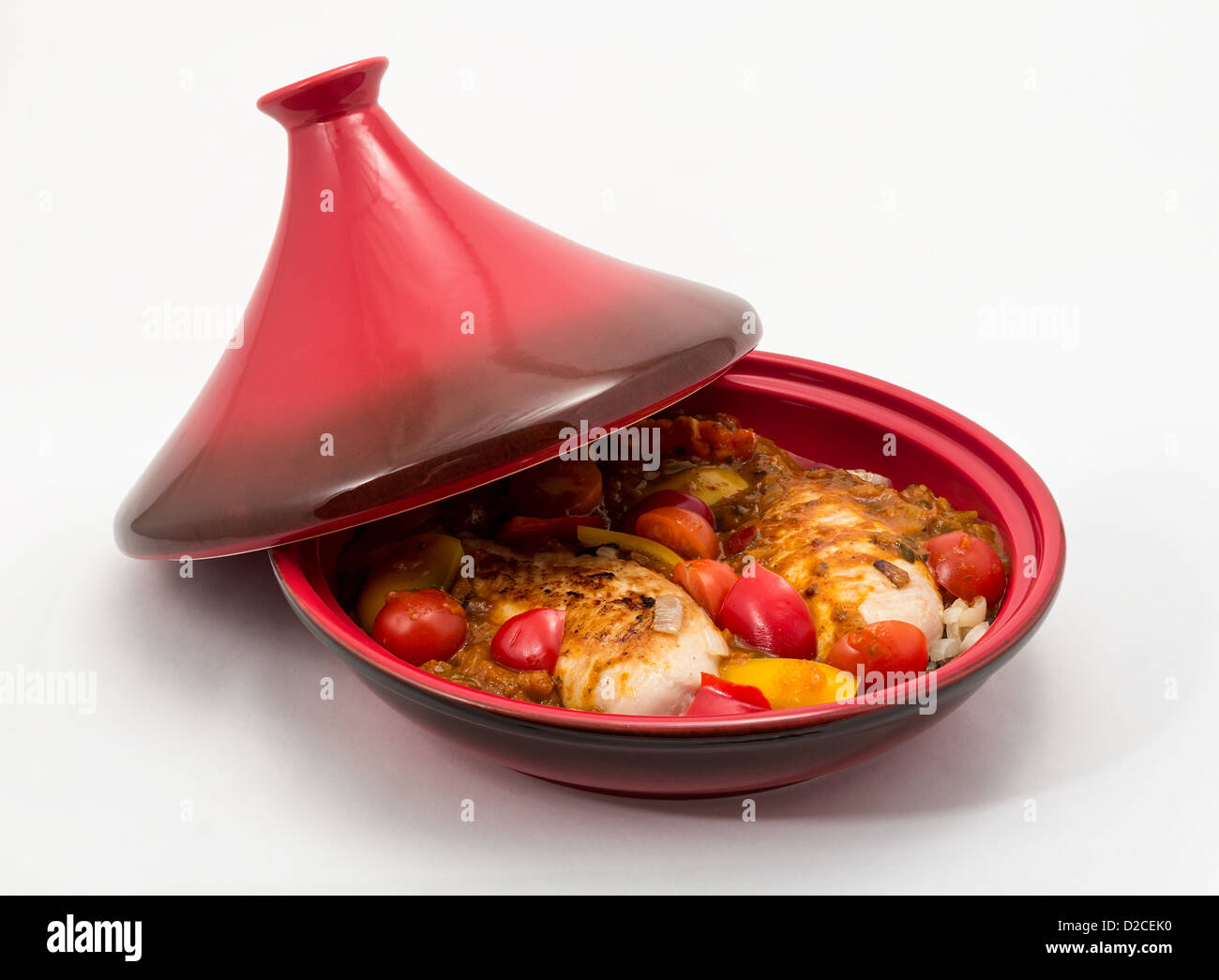 Tagine (Tajine) a type of cookware from Morocco, shown here with a prepared chicken dish ready for cooking. Stock Photo