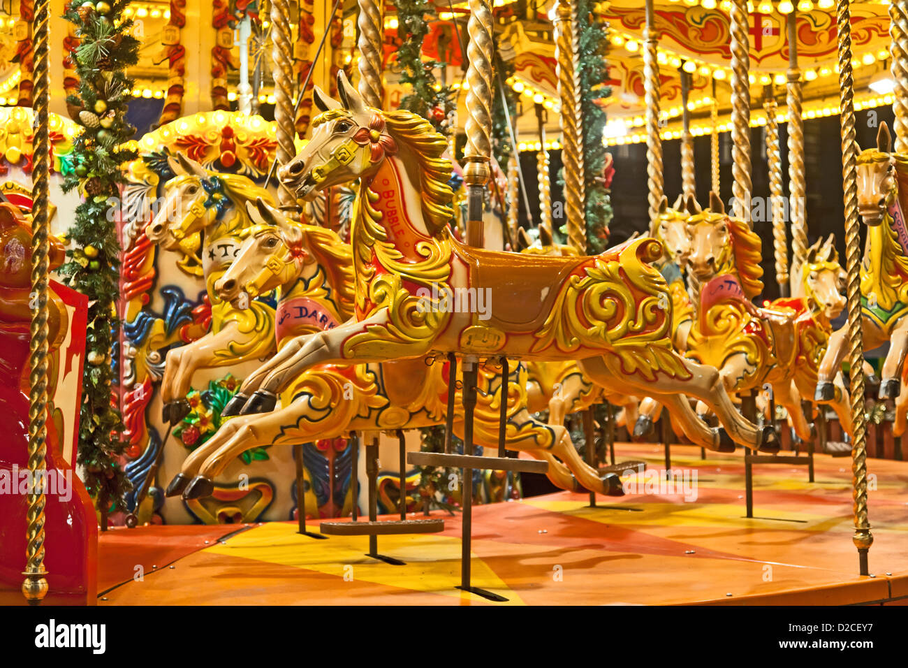 Carousel horses lit up at night in George Square, central Glasgow, Scotland Stock Photo
