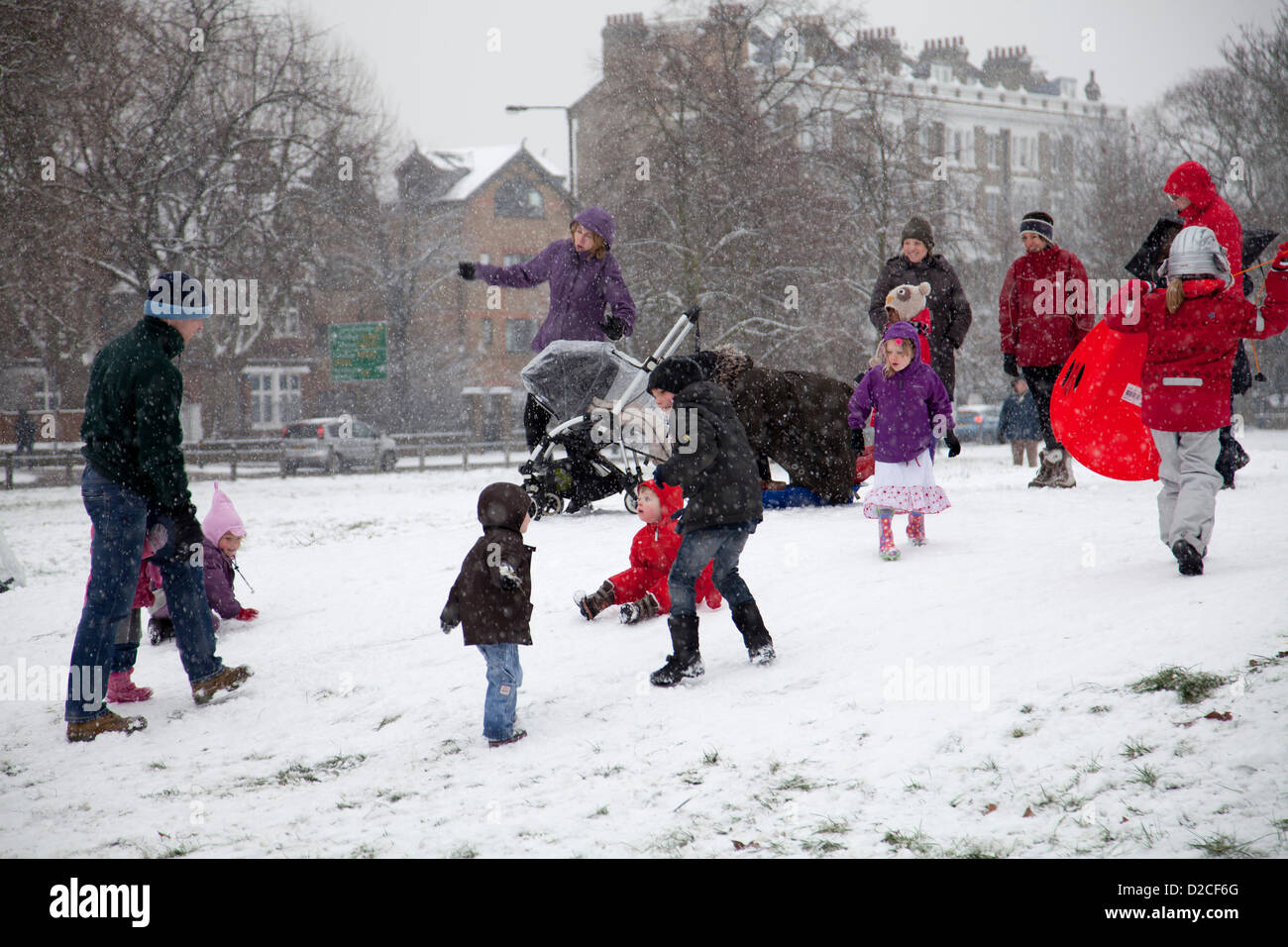 20 January 2013  13.17 PM - Snow falls on Clapham Common in Clapham, London, UK. Children and parents  playing in the snow. Stock Photo