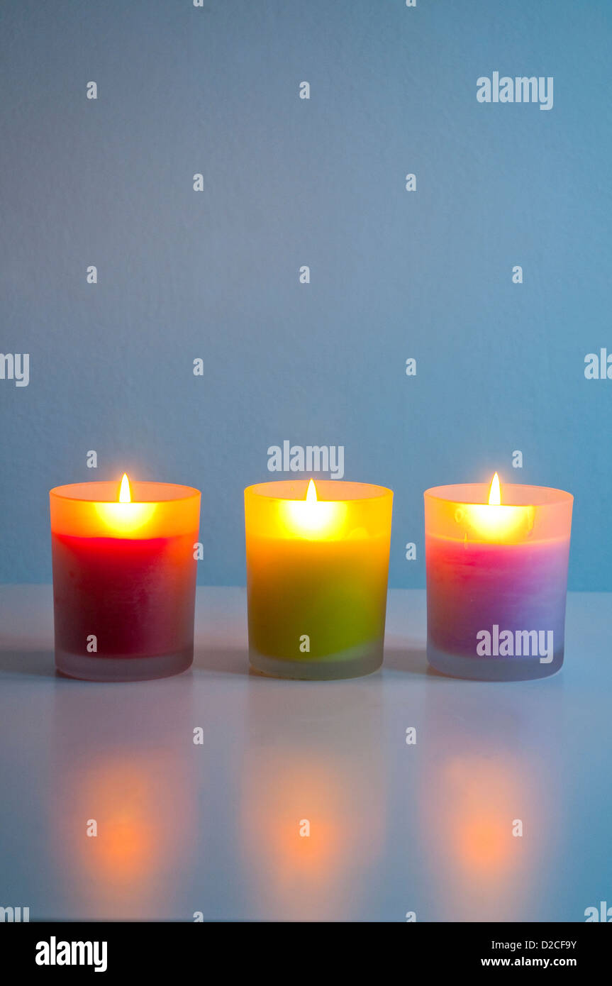 Three lit up candles Stock Photo Alamy