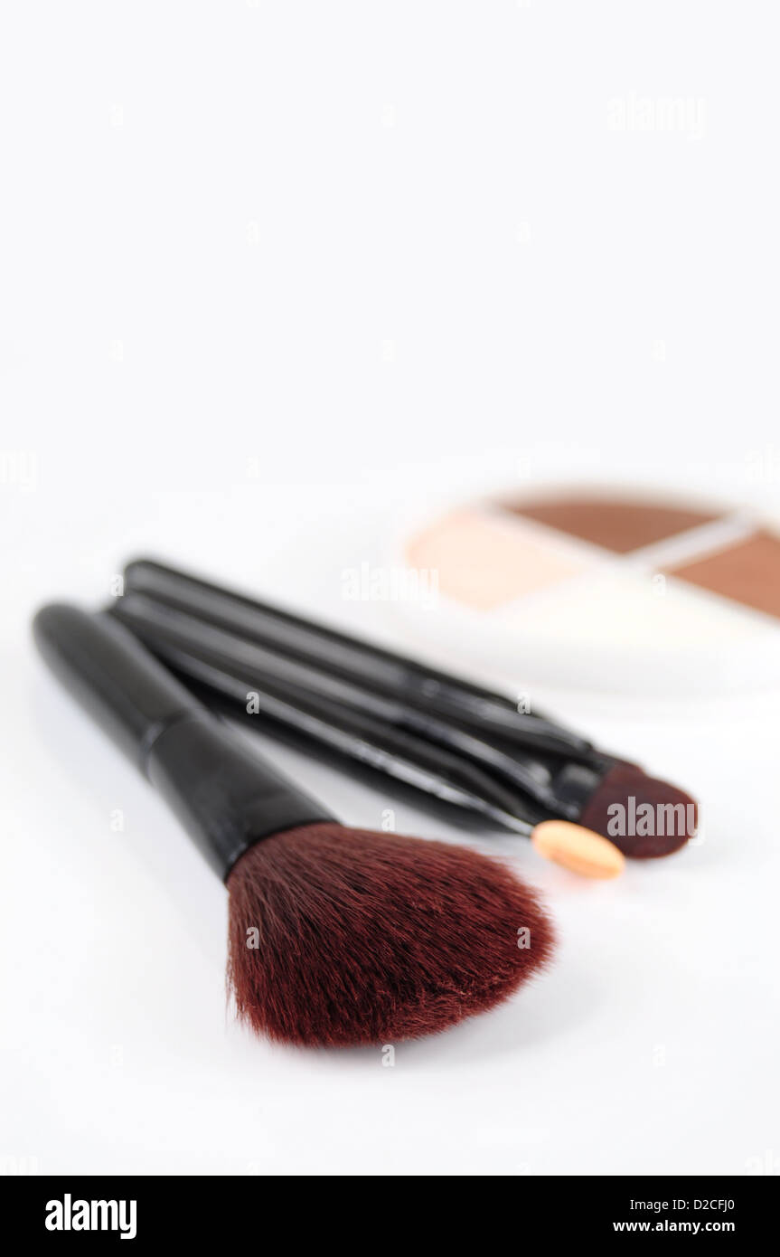 Closeup of brushes for makeup, eye shadows in the background Stock Photo