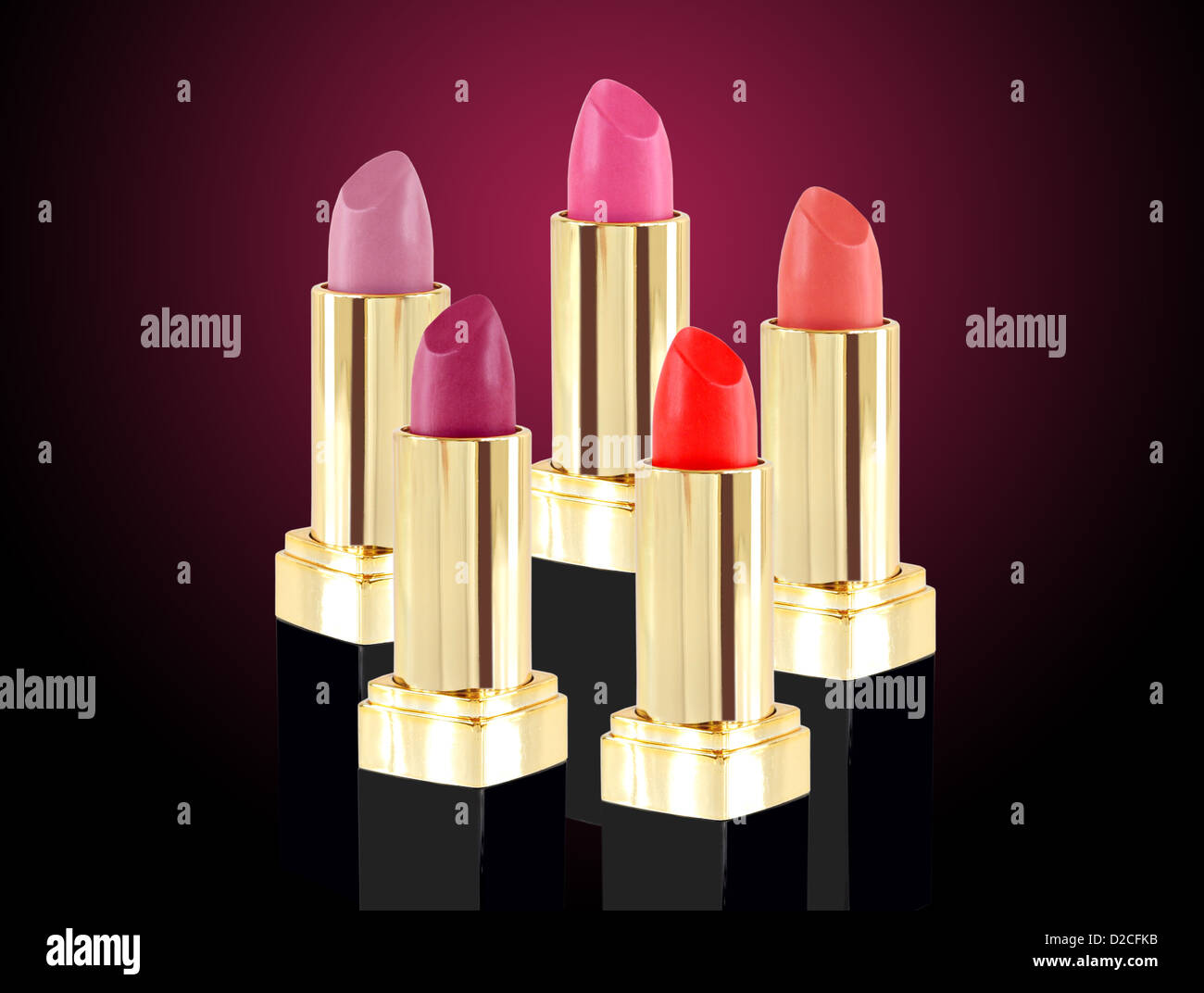 Lipstick in various colors on pink background Stock Photo