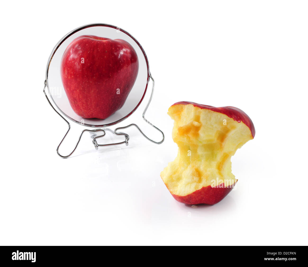 Fat and slim apple in mirror - metaphor for eating disorder Stock Photo
