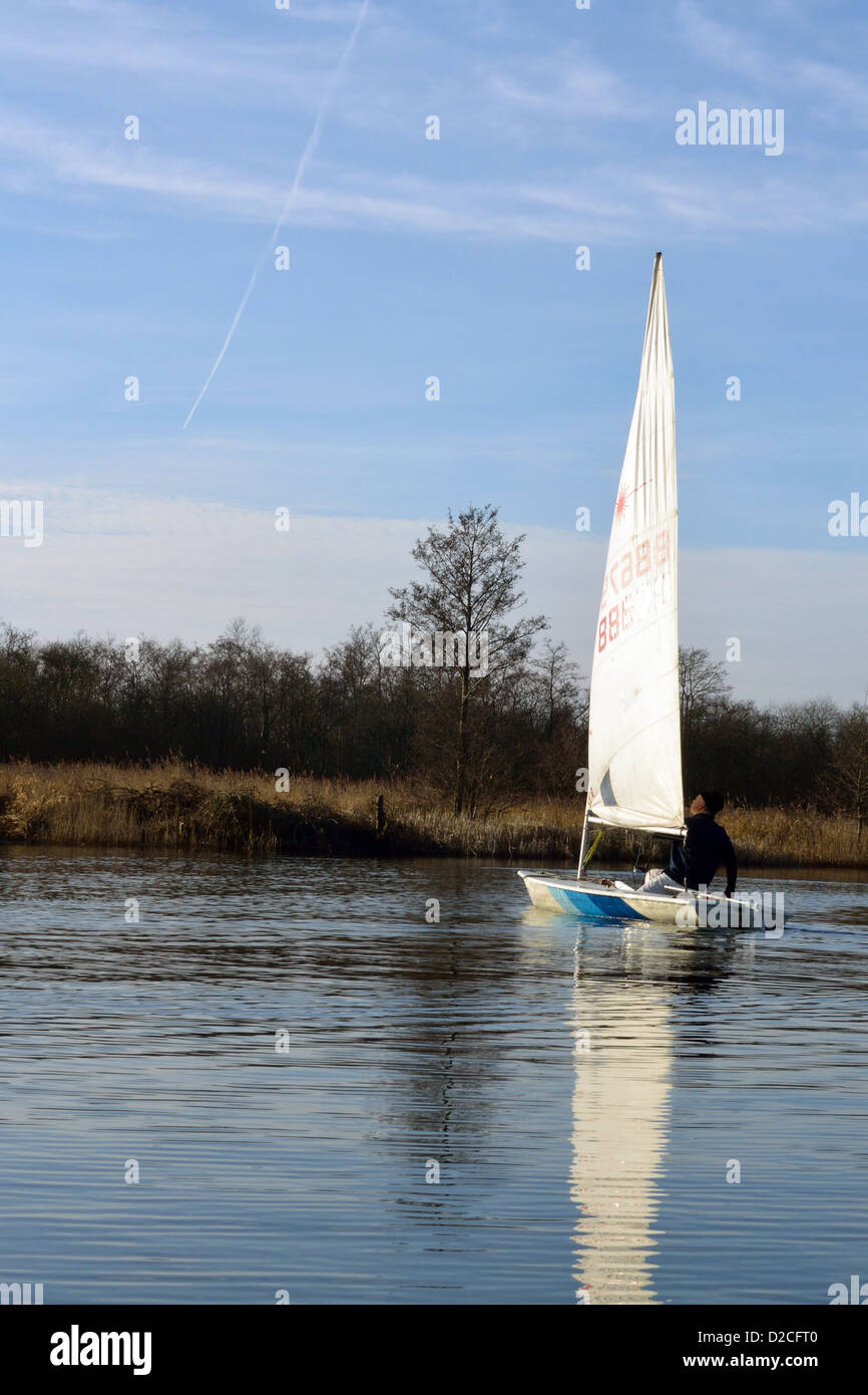 Laser sailing dinghy on the River Bure near Horning, Norfolk, Broads