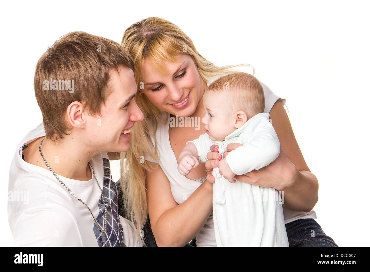 Portrait of a young happy family: mother, father and baby smiling ...