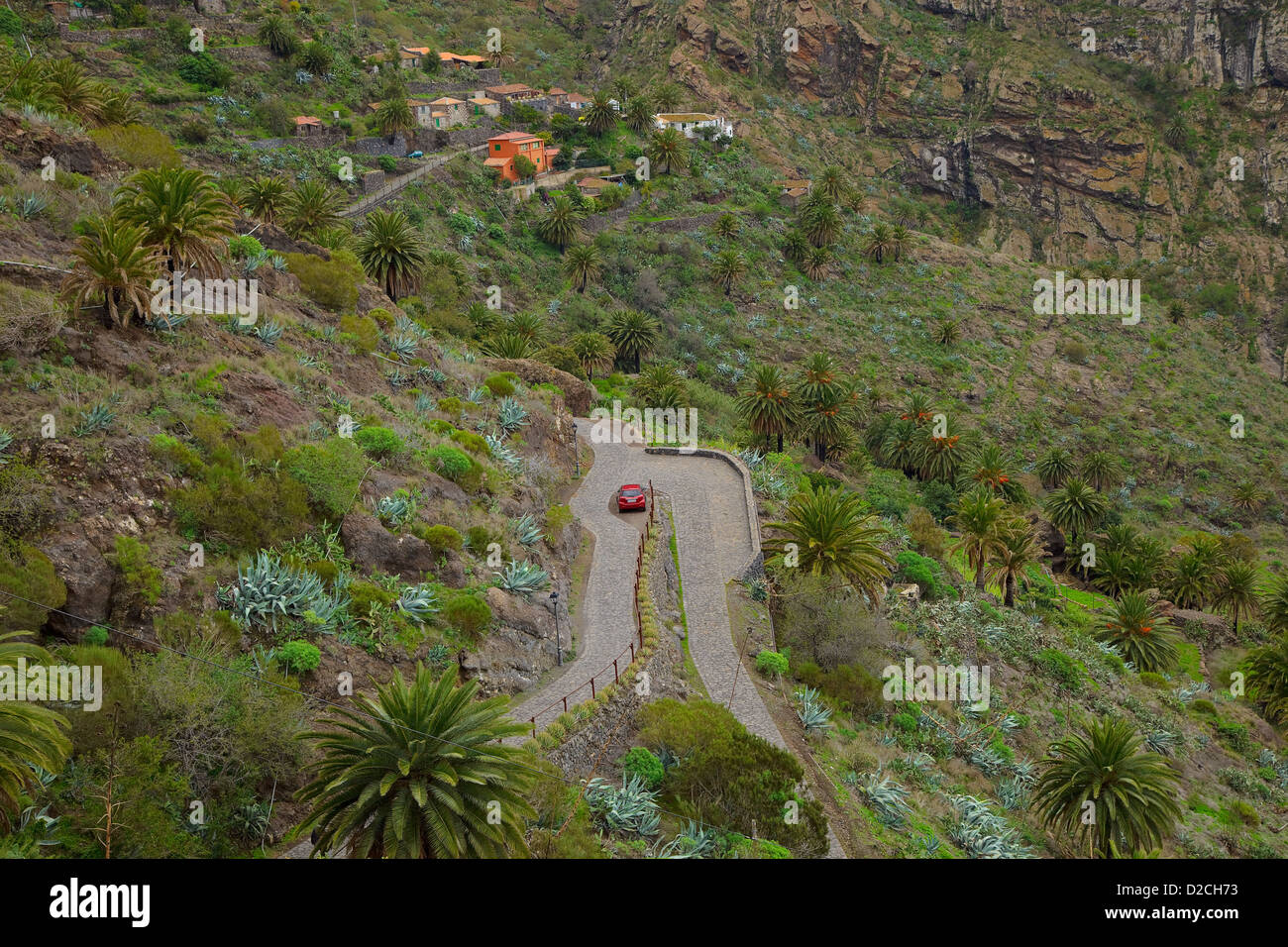 Mountain winding road with a red car Stock Photo