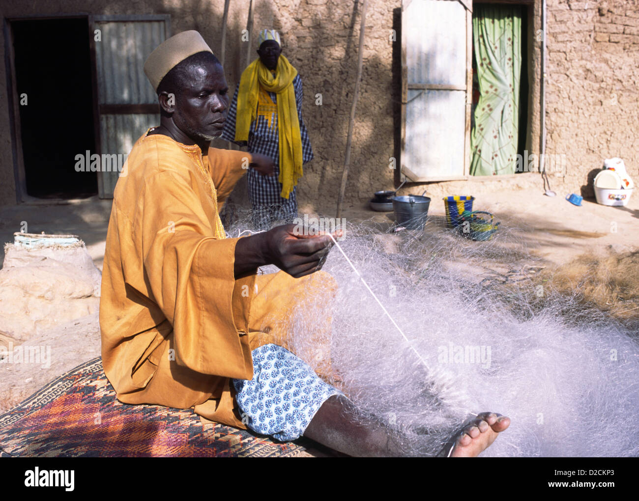 A Bozo fisherman preparing his nets in Mali, West Africa. Bozo are one of the ethnic groups in Mali. Stock Photo