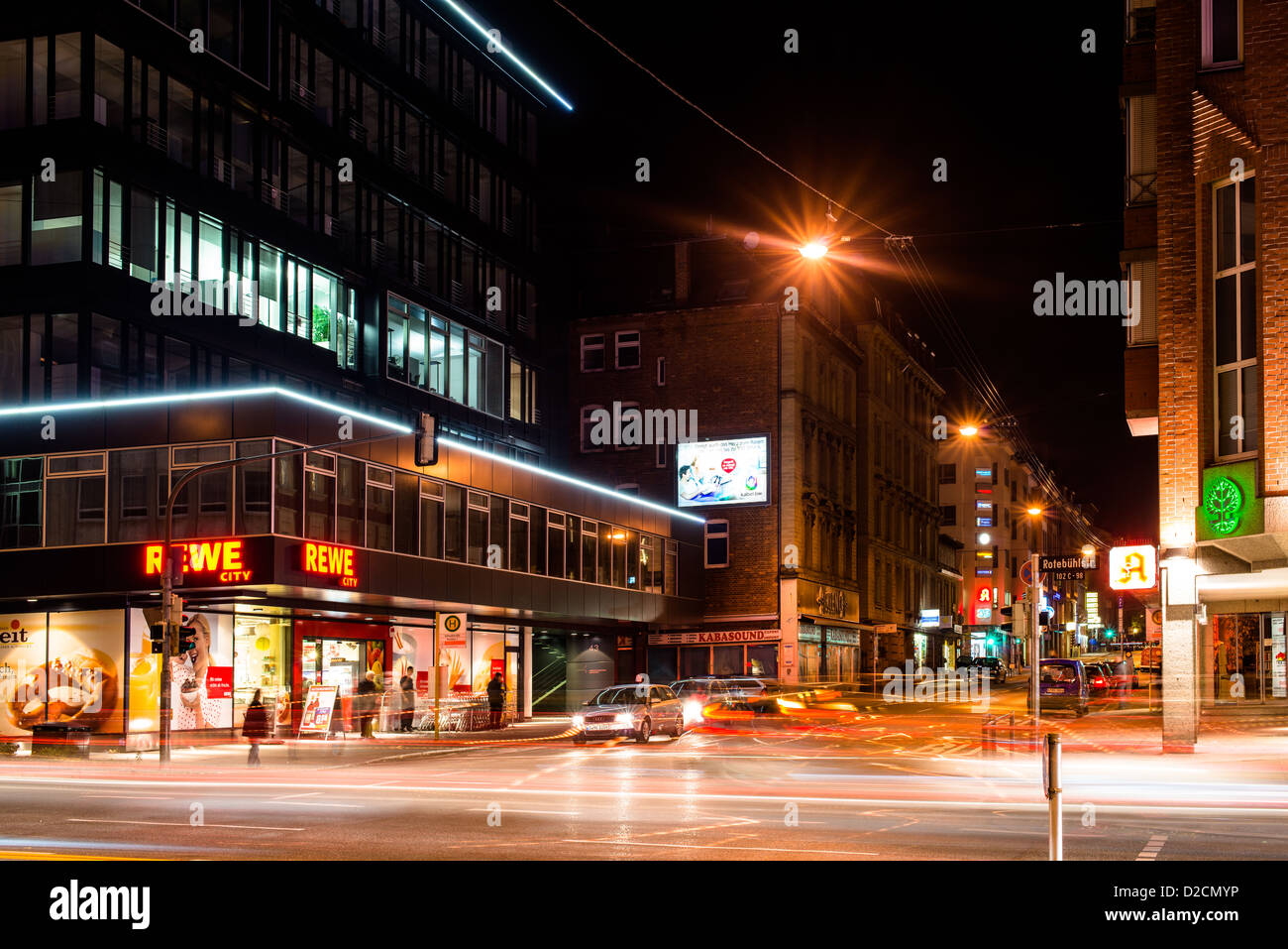 Vivid night scenery showing light traces of cars passing by in long exposure at an intersection on November 8, 2012 in Stuttgart Stock Photo