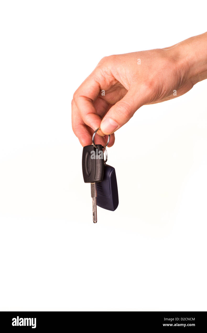 Male hand holding a car key isolated on white. New car concept Stock Photo