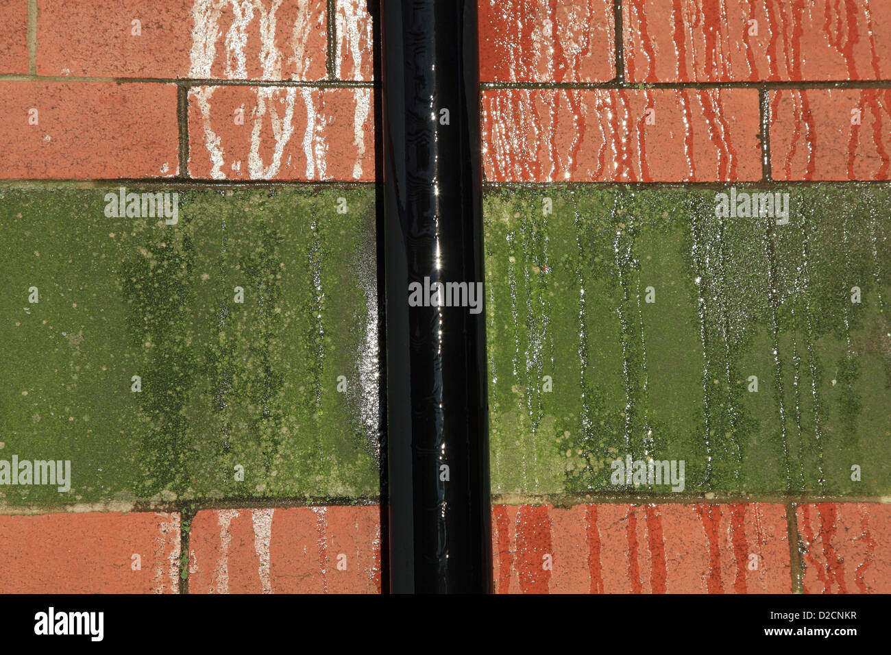 Partially frozen water overflowing along a drain pipe with a decorative