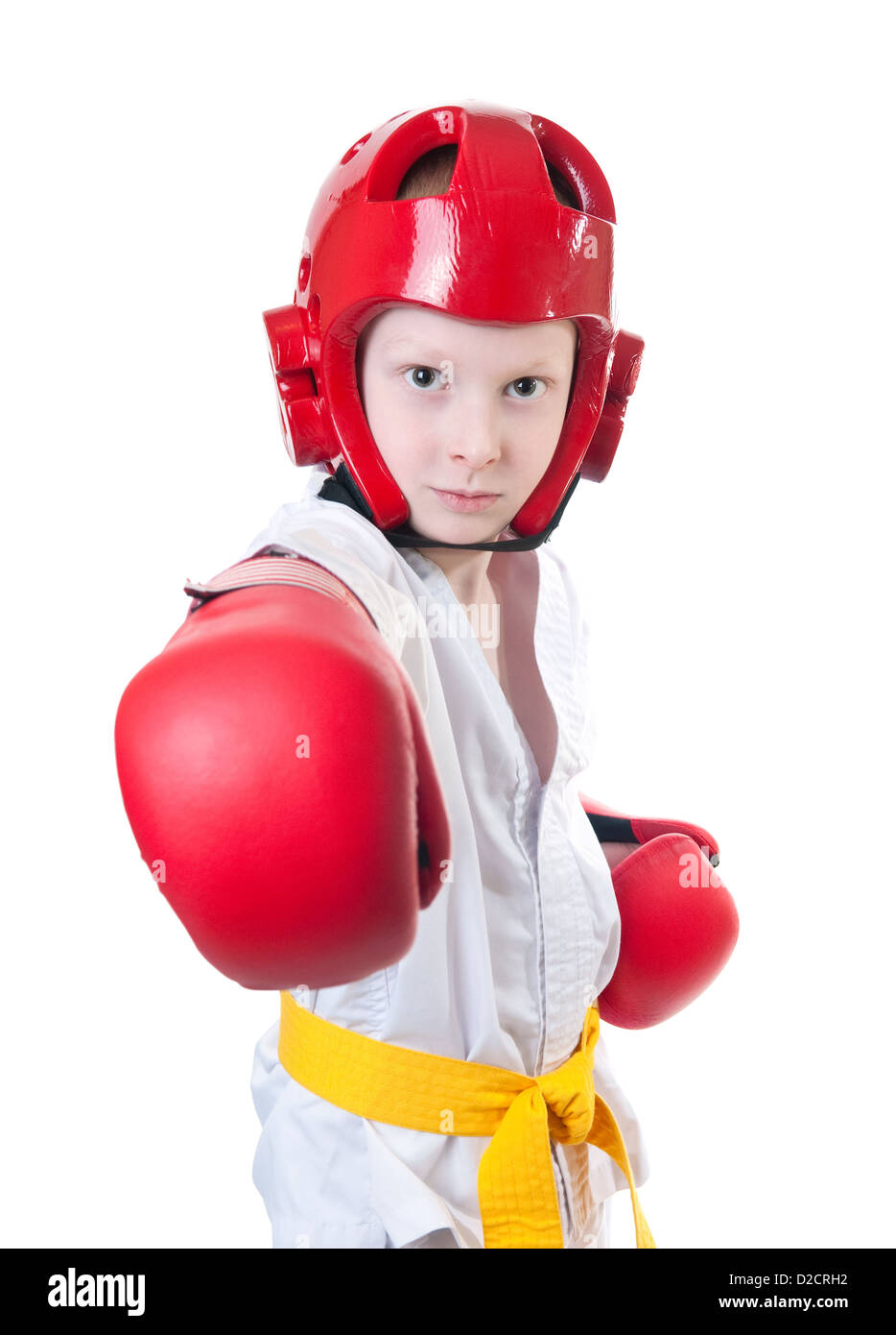 Young boy wearing tae kwon do uniform, protective helmet and boxing gloves Stock Photo